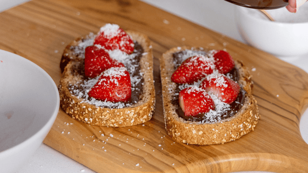 Tostadas con crema de avellana y cacao, fruta y coco
